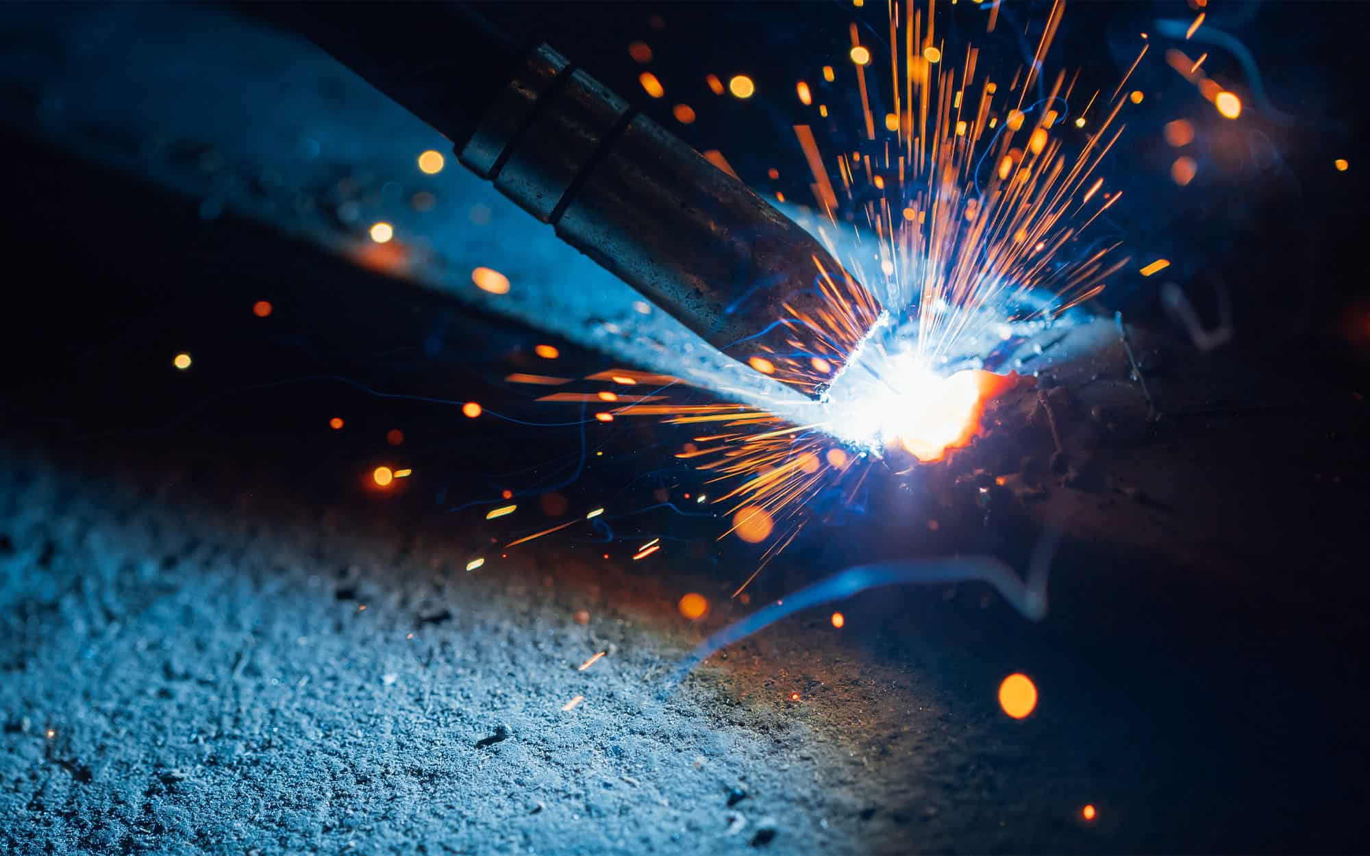 Artistic-welding-sparks-light,-industrial-background