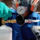 Image of a person calibrating a tank of gas.