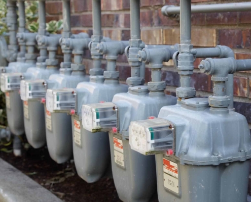 Side view of a row of gas meters with full manifolding