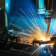 Worker, Welding In A Car Factory With Sparks